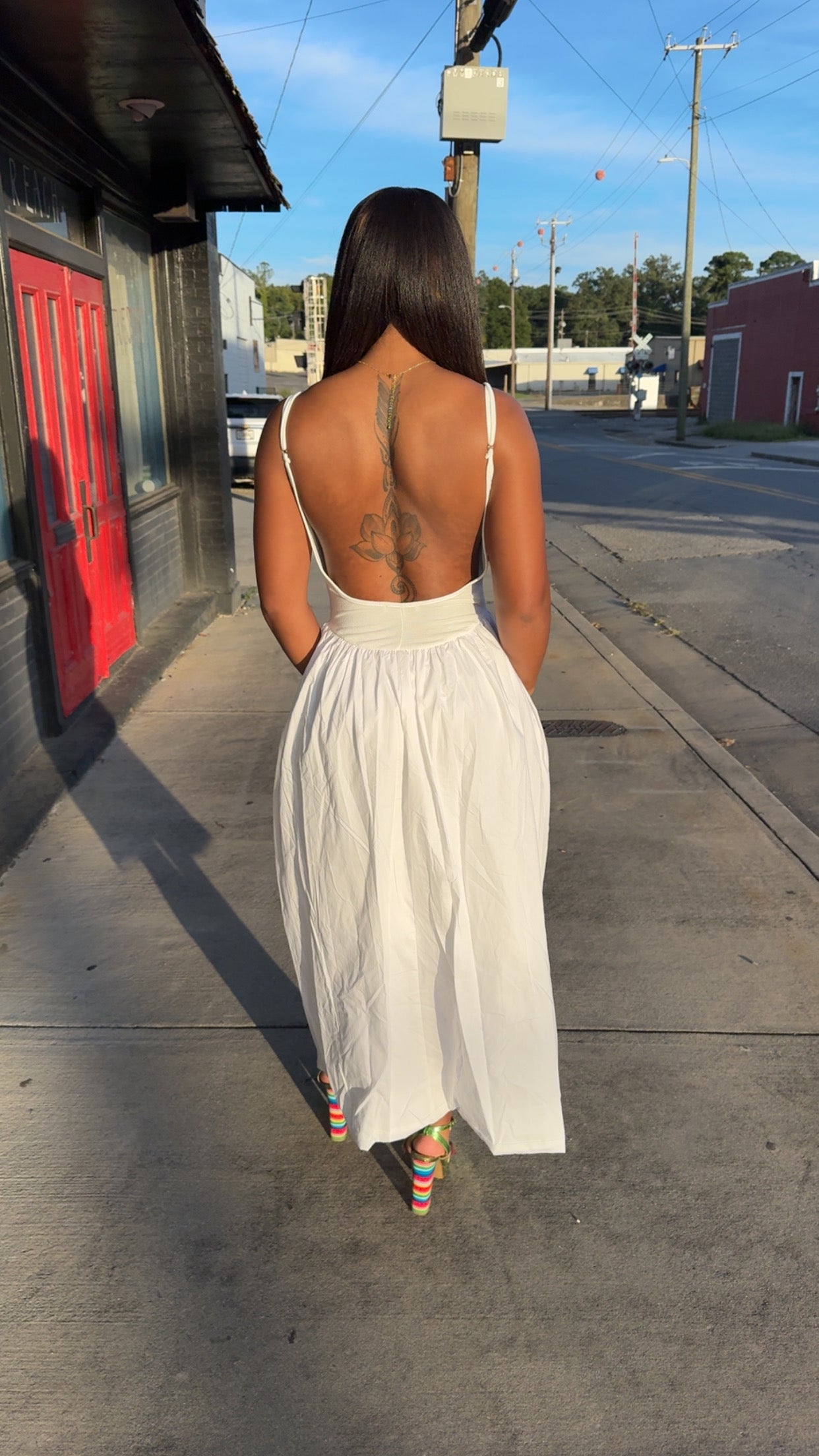 White low back dress with pockets.